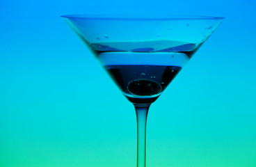 conceptually illuminated martini glass on gradient background
