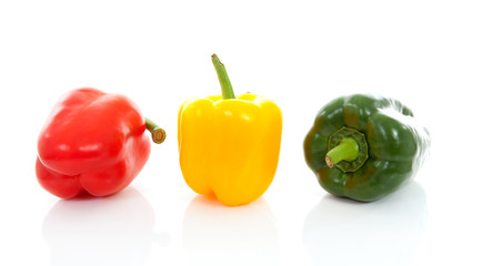 three fresh paprika over white background