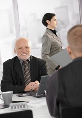 Senior businessman smiling at work