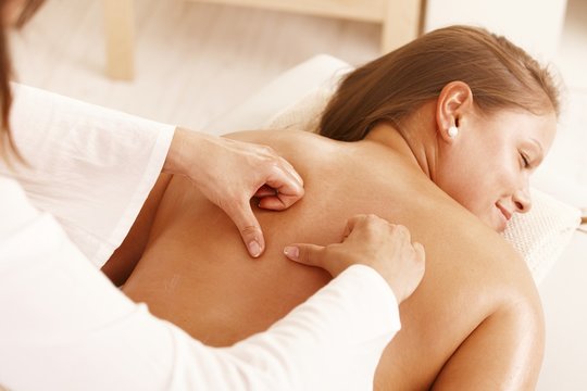 Young woman getting back massage