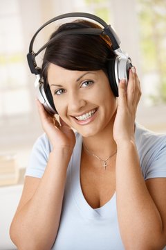 Happy woman enjoying music on headphones