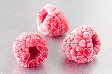 Delicious frozen raspberries on steel
