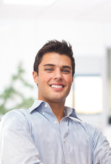 Smiling businessman with office background