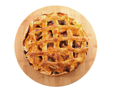 Delicious home baked apple pie on wooden cutting board