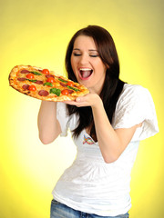 Pretty young casual woman eating tasty pizza
