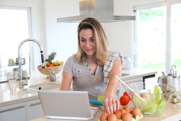 Woman in kitchen preparing lunch