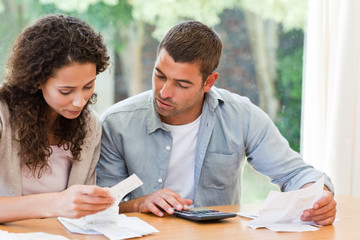 Young couple calculating their domestic bills
