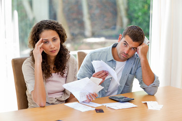 Young couple calculating their domestic bills