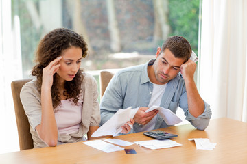 Young couple calculating their domestic bills