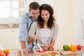 Obraz na płótnie Canvas Handsome man cooking with his girlfriend