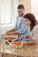 Obraz na płótnie Canvas Handsome man cooking with his girlfriend