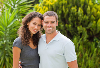 Happy couple hugging in the garden