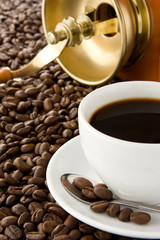 cup of coffee and grinder on beans