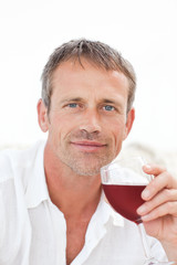 Handsome man drinking some red wine