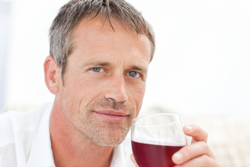 Fototapeta premium Handsome man drinking some red wine