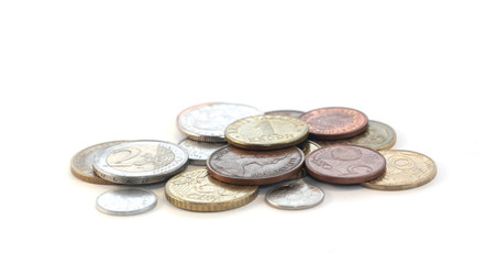 metal coins from different countries on the table
