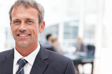 Fototapeta premium Smiling businessman in his office