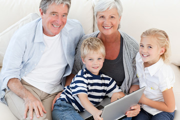 Adorable family looking at their laptop