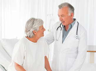 Doctor helping his patient to walk
