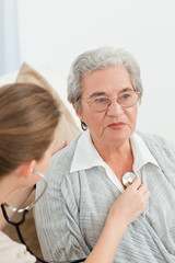 Nurse taking the heartbeat of her patient