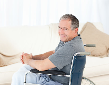 Mature man in his wheelchair looking at the camera