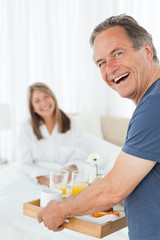 Obraz na płótnie Canvas Man bringing breakfast to his wife