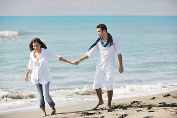 happy young couple have fun at beautiful beach