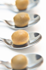 Green olives aligned on teaspoons