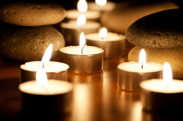 Burning candles and pebbles for aromatherapy session