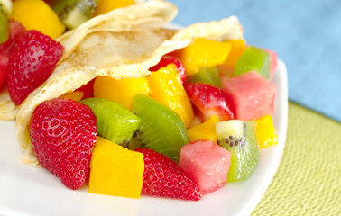 Crepes filled with fruits: strawberry, kiwi, mango, melon