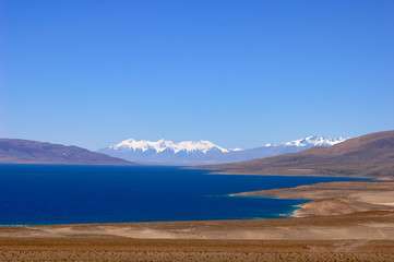 Landscape of blue lake and snow covered mountains