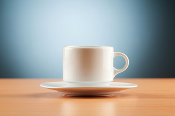 White cup against colourful gradient on the table