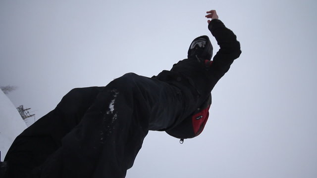 Snowboarder coming down on a snowboard