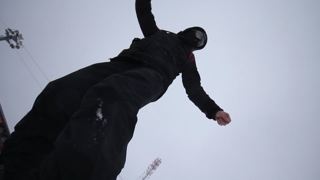 Snowboarder coming down on a snowboard