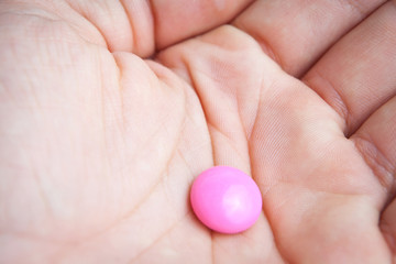 Taking pills/taking painkillers - hand holding two pills