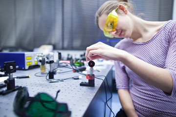 female scientist doing research in a quantum optics lab (color t