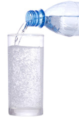 water pouring down from plastic bottle into glass