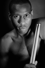 Close-up of young drummer with dramatic lighting