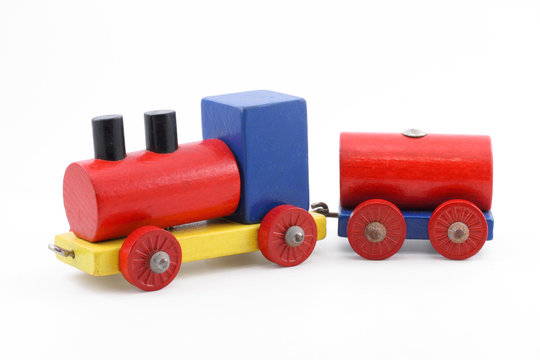 Colorful miniature wooden toy train on white background