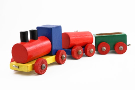 Colorful miniature wooden toy train on white background