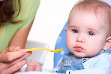 Mother feeding hungry baby