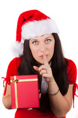 young girl in red smiling with christmas clothes and gift box