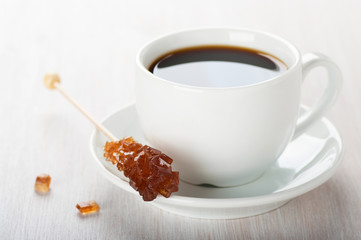 Candy sugar brown on a stick and coffee