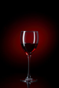 glass of red wine on black background