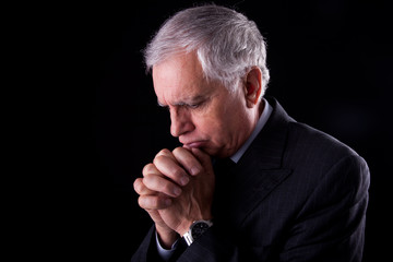 Portrait of a handsome mature businessman, thinking-praying