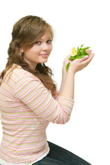 Closeup portrait of a beautiful happy young woman holding plant
