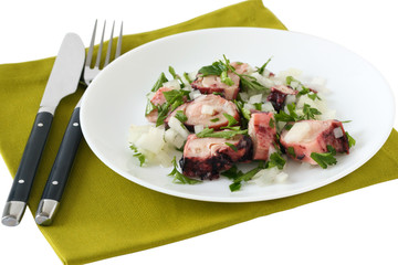 octopus salad with parsley on an white plate