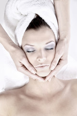 Fototapeta na wymiar Beautiful young woman receiving facial massage.