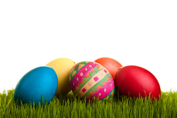 Fototapeta na wymiar Easter eggs on green grass on white isolated backgr