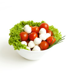 bowl with mozzarella,tomatoes and green salad leafs